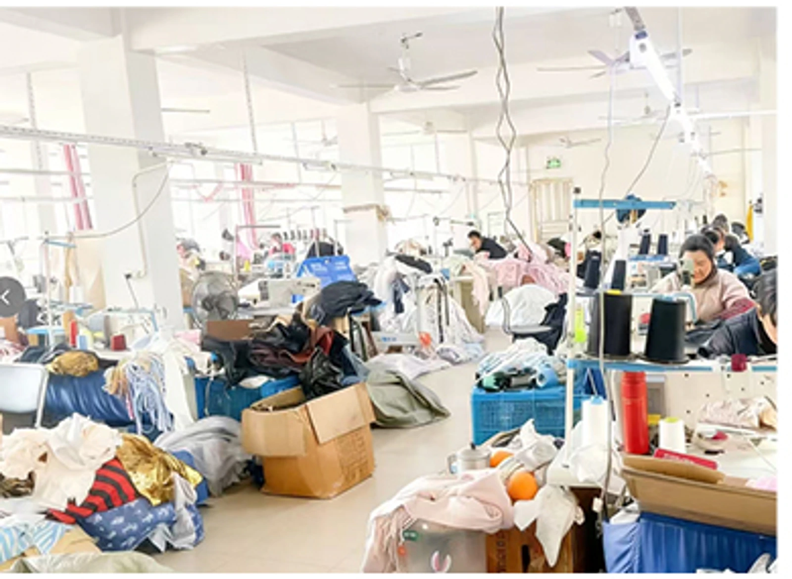 Sewing stations and garment pieces in the clothing workshop
